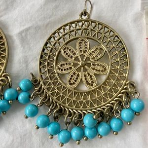 Gold colored earrings with turquoise beads